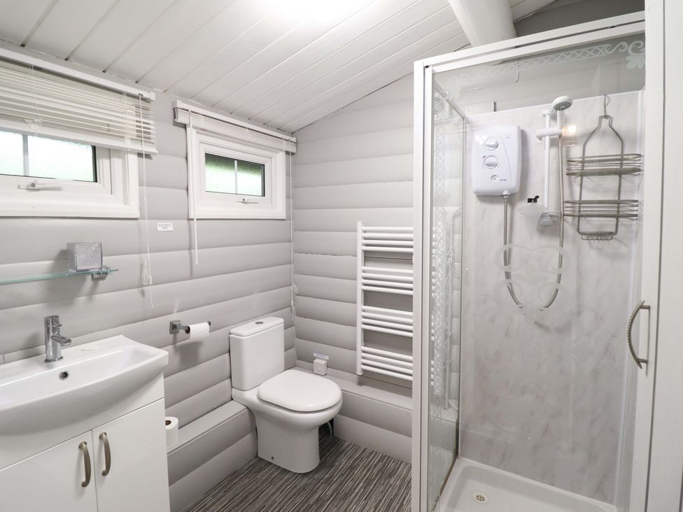 A bathroom with a shower and sink at Swn Yr Afon - No 333