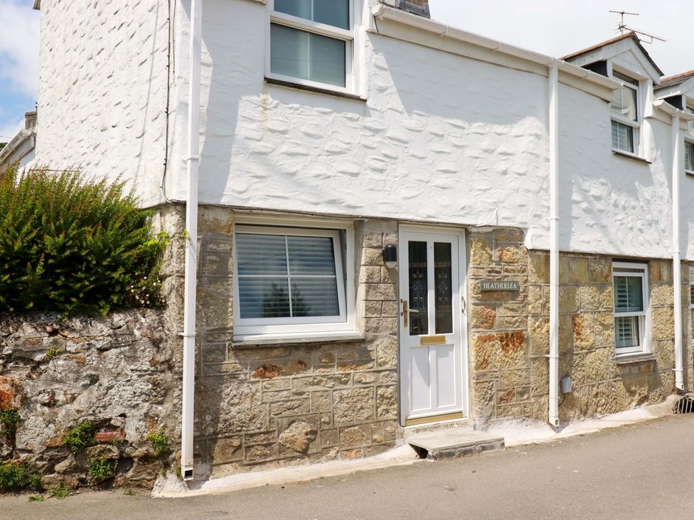 A house exterior with a door and windows at Heatherlea Cottage St. Austell