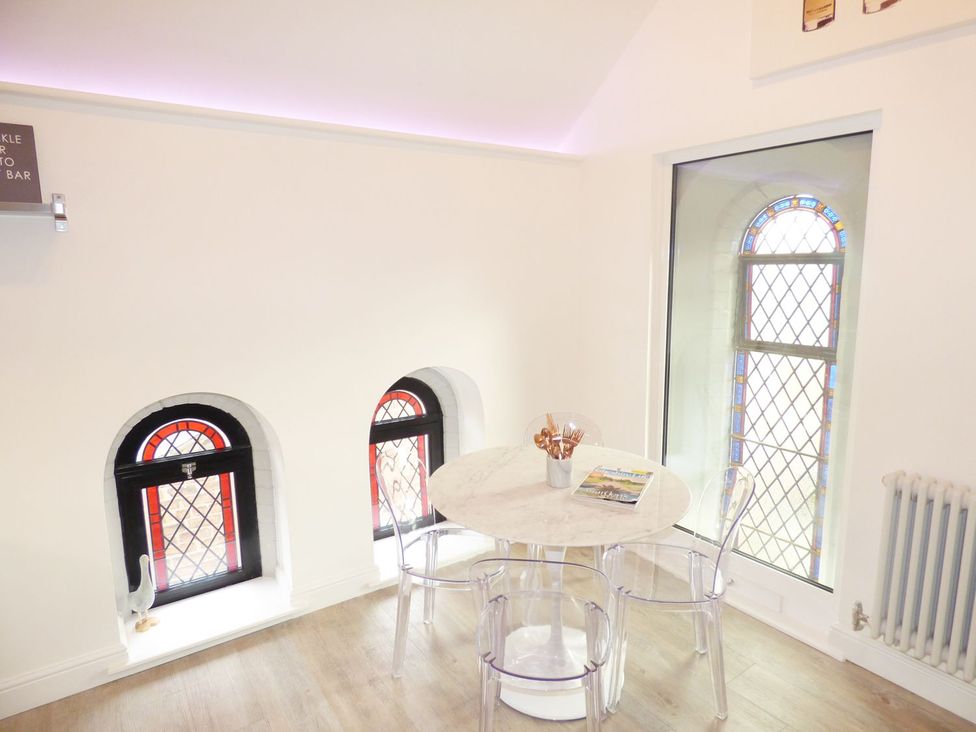A dining area with a table and chairs at 1 Chapel Place, Chester
