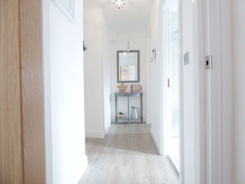 A hallway with a console table and a mirror at 1 Chapel Place in Chester
