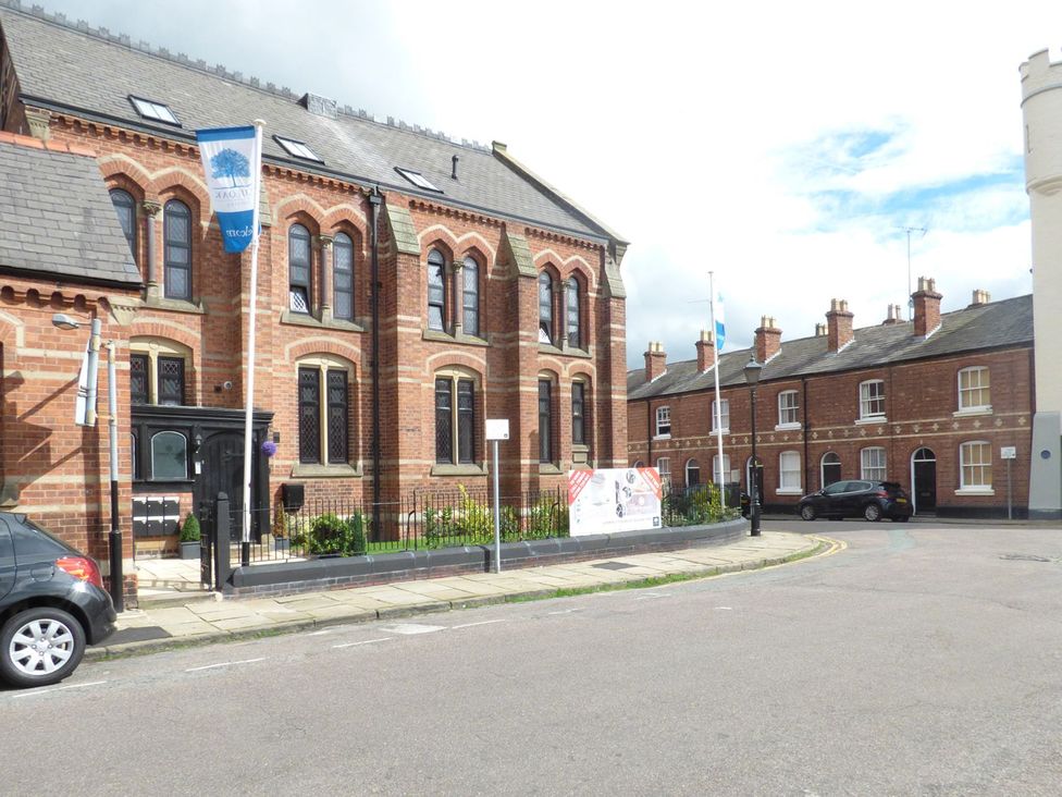 A building with windows and a flag on the side at 1 Chapel Place Chester