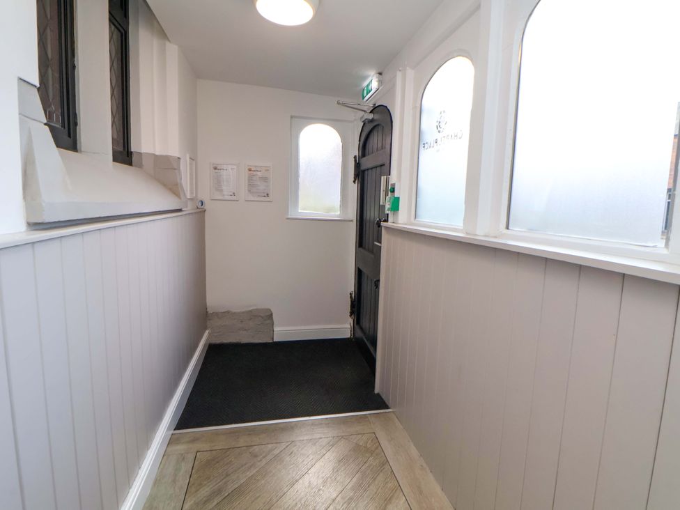 A hallway with a door and windows at 1 Chapel Place Chester