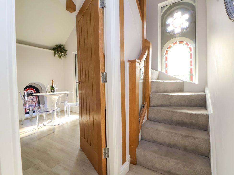 A hallway with a view of a dining area and staircase at 1 Chapel Place Chester