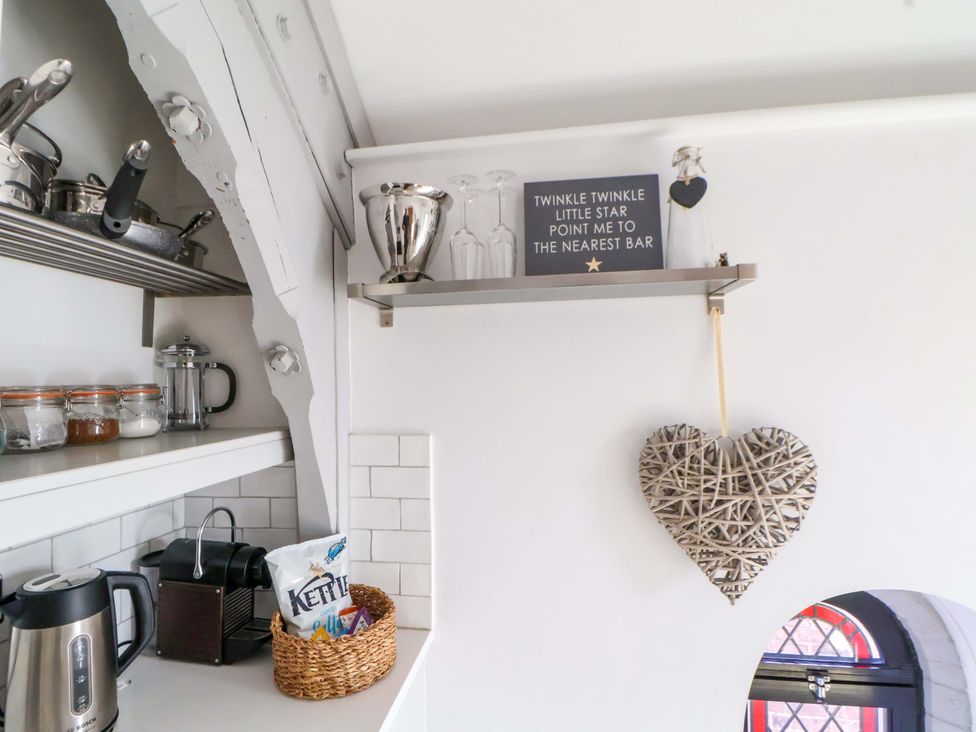 A kitchen with shelves and utensils at 1 Chapel Place Chester