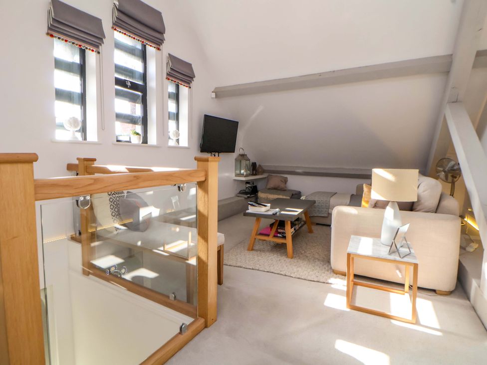 A living room with a sofa and television at 1 Chapel Place Chester