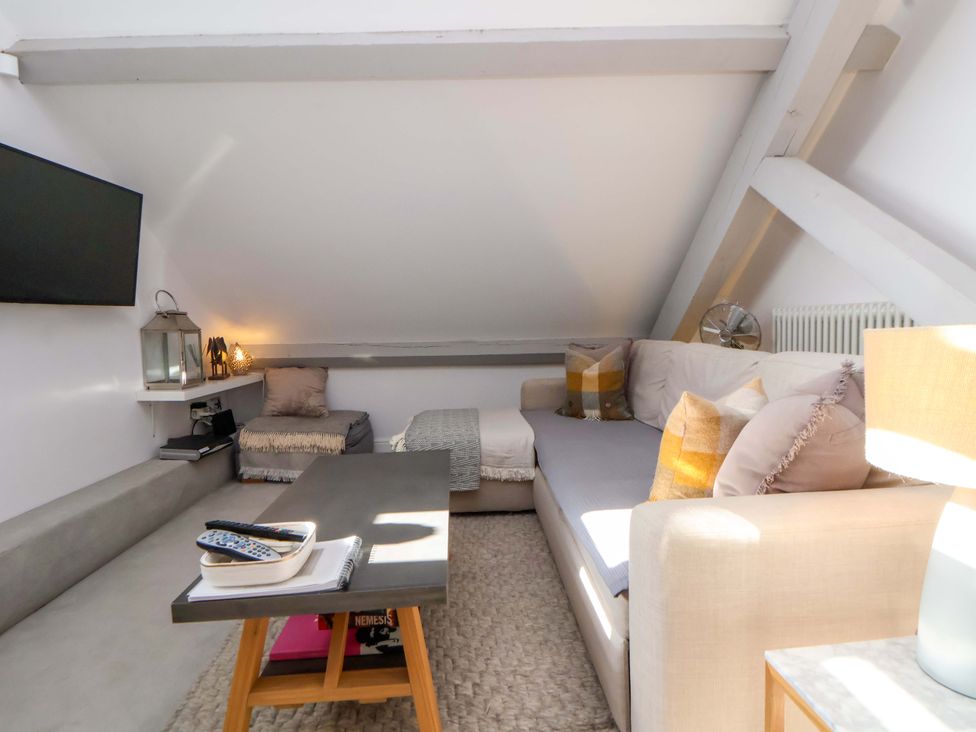 A living room with a television and sofa at 1 Chapel Place Chester