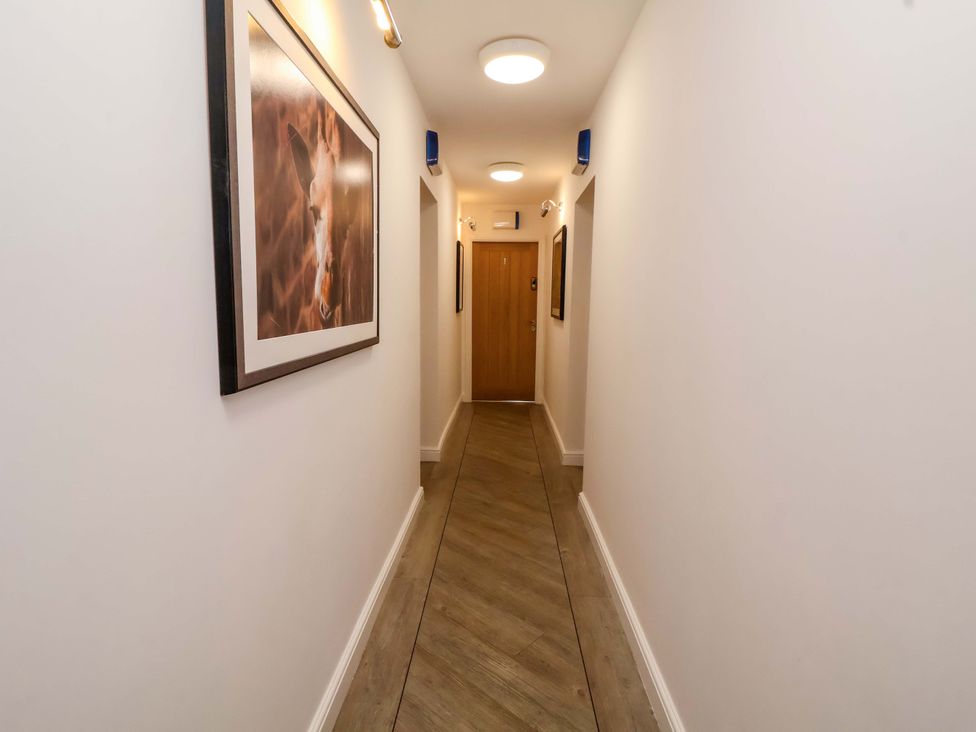 A hallway with a door and framed artwork at 1 Chapel Place Chester