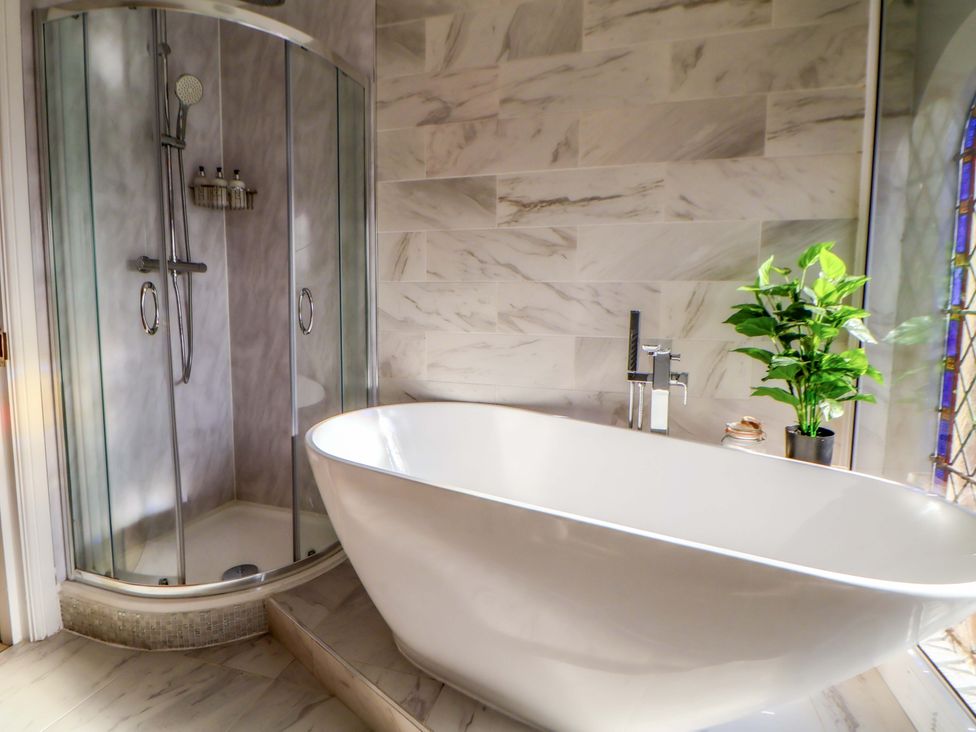 A bathroom featuring a bathtub and a shower at 1 Chapel Place Chester