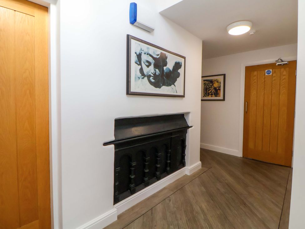 A hallway with artwork and a fireplace at 1 Chapel Place Chester