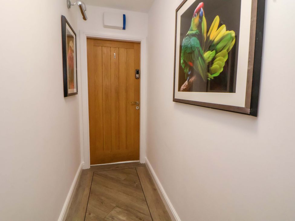A hallway with a door and framed artwork at 1 Chapel Place Chester