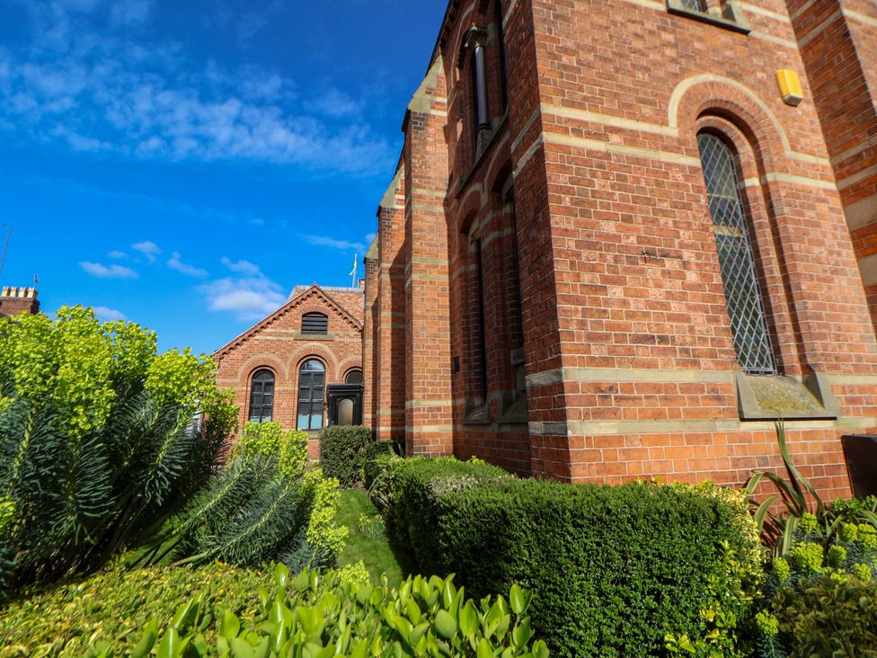 A brick building with windows and garden at 1 Chapel Place Chester