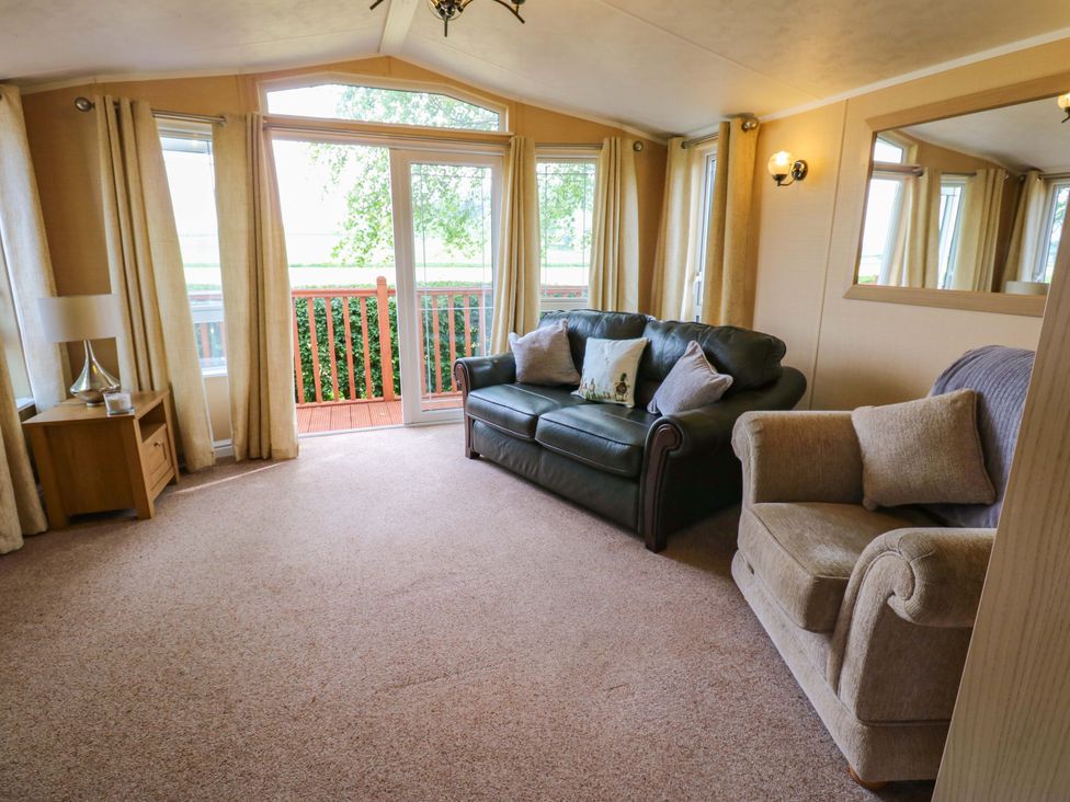 A living room with sofas and a coffee table at Plot 12 in Carlisle