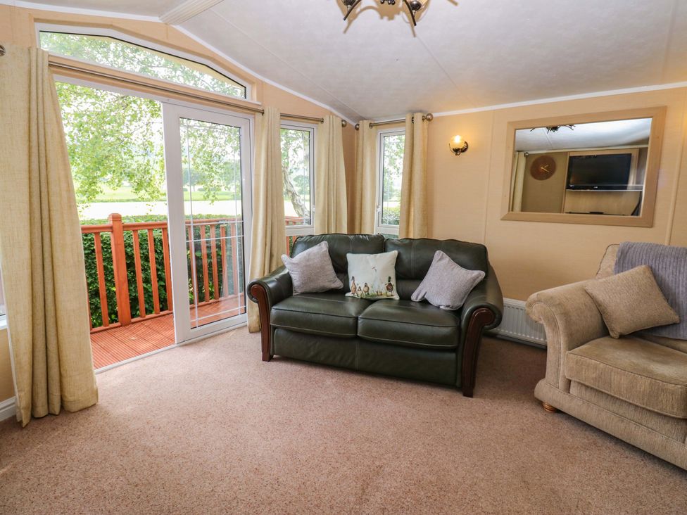 A living room with two sofas and a television at Plot 12 in Carlisle