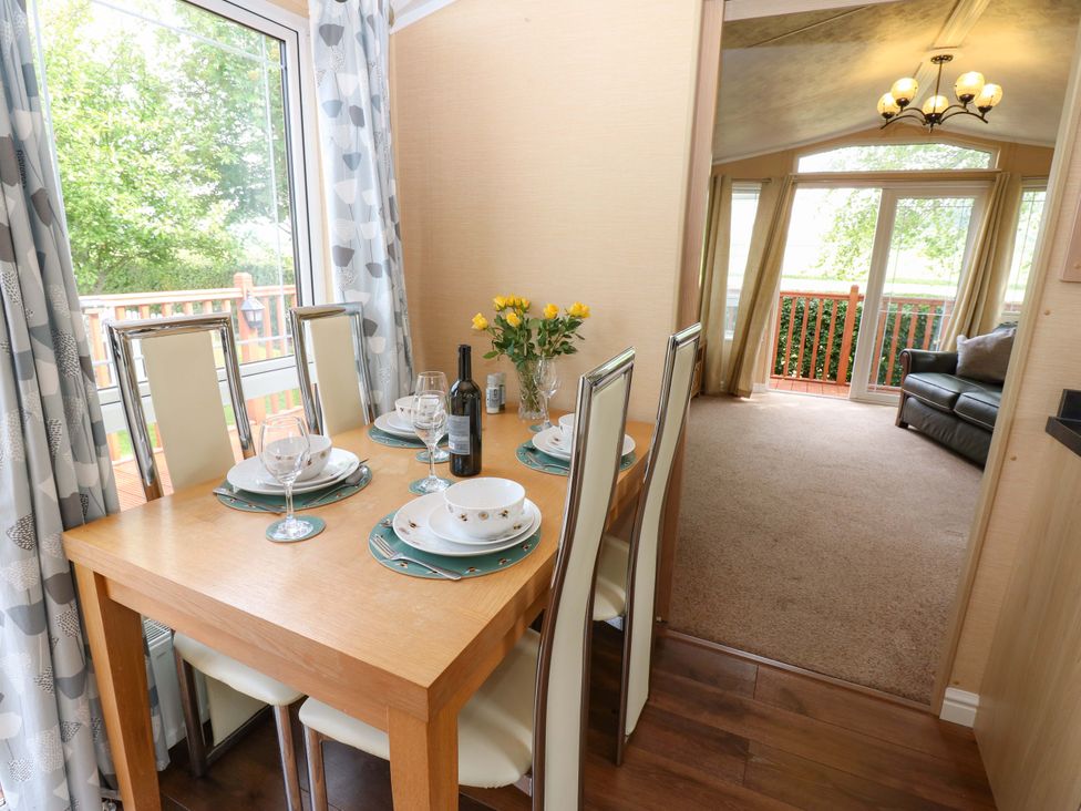 A dining area with a table set for a meal at Plot 12 Carlisle