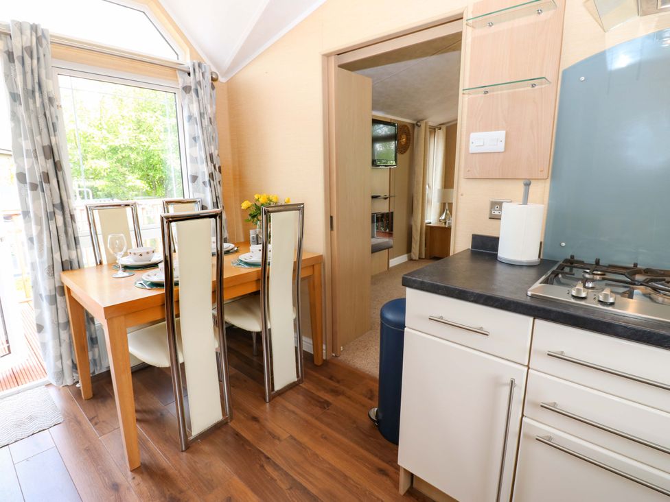 A dining room with a table and chairs at Plot 12 in Carlisle
