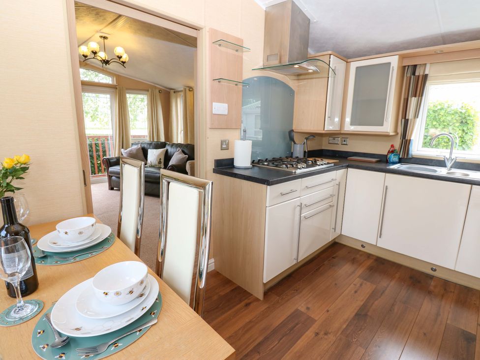 A kitchen with dining table and chairs at Plot 12 in Carlisle