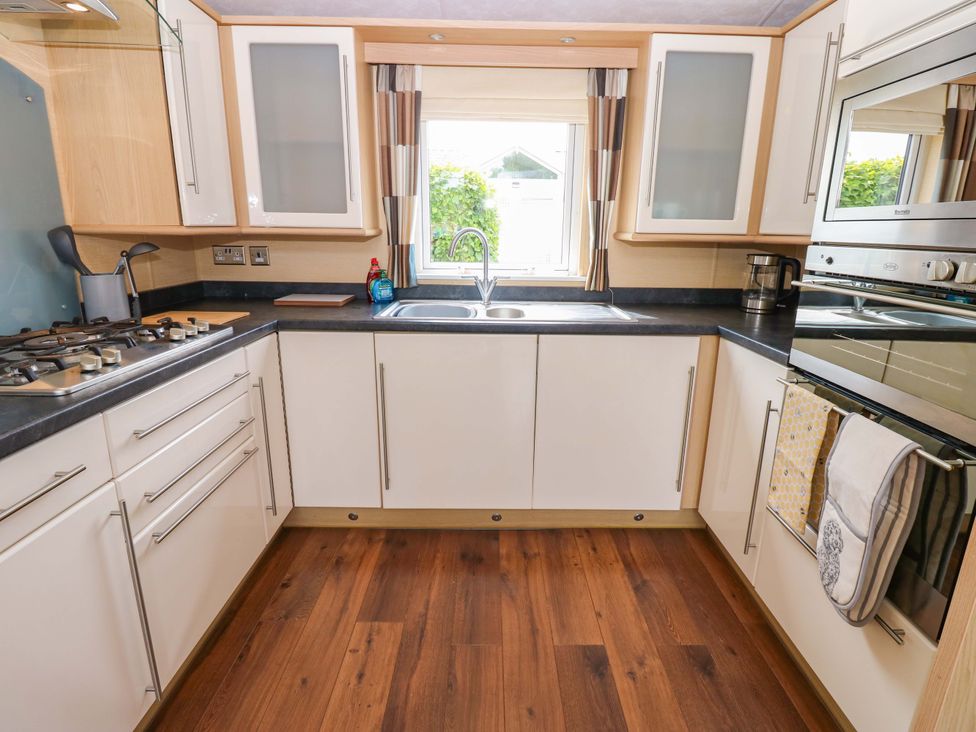 A kitchen with a sink and gas stove at Plot 12, Carlisle