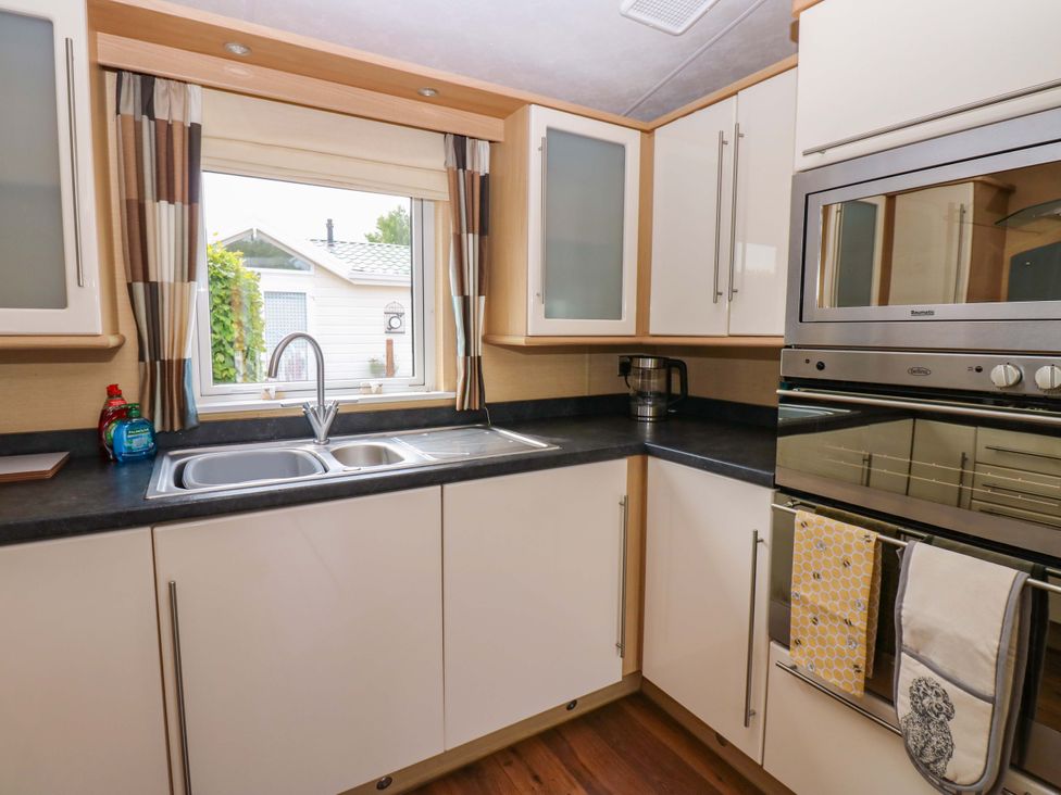 A kitchen with cabinets and appliances at Plot 12 Carlisle