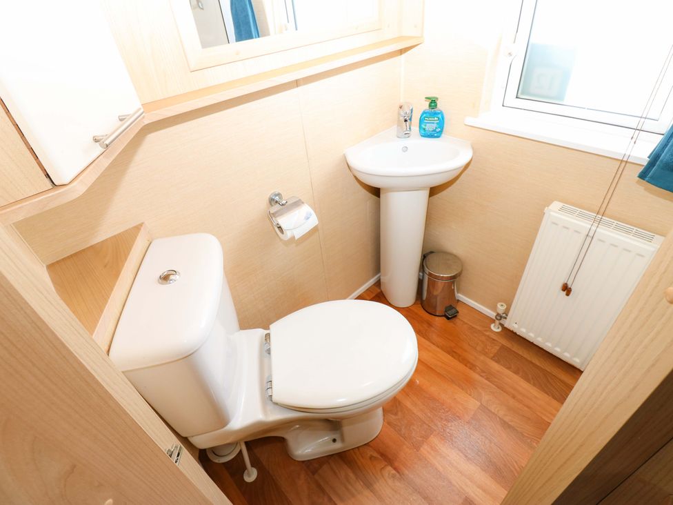 A bathroom with toilet and sink at Plot 12 in Carlisle