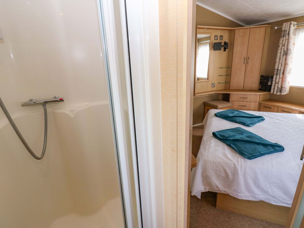 A bedroom with a shower and bed at Plot 12 in Carlisle