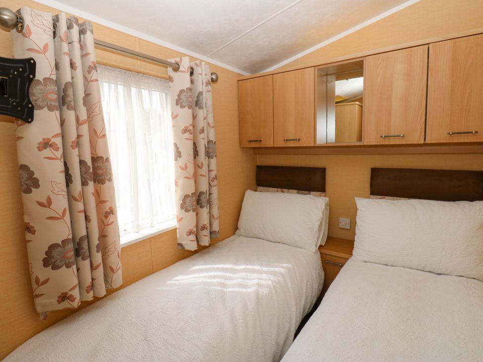 A bedroom with two beds and a window at Plot 12 in Carlisle
