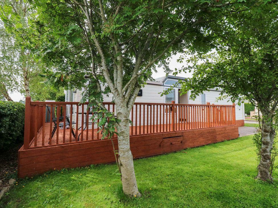 A deck with railing and trees at Plot 12 in Carlisle
