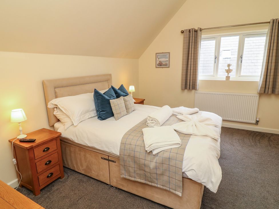 A bedroom with a double bed and bedside lamp at Lodge 7 in Brigg