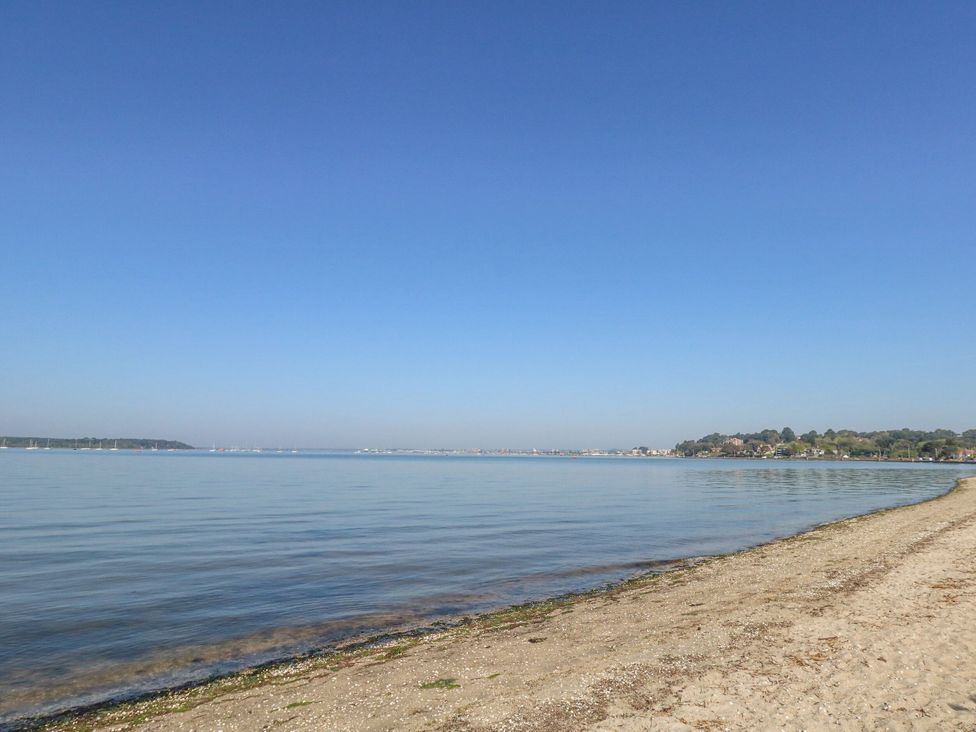 A beach with water and sand at Apartment 11 in Poole