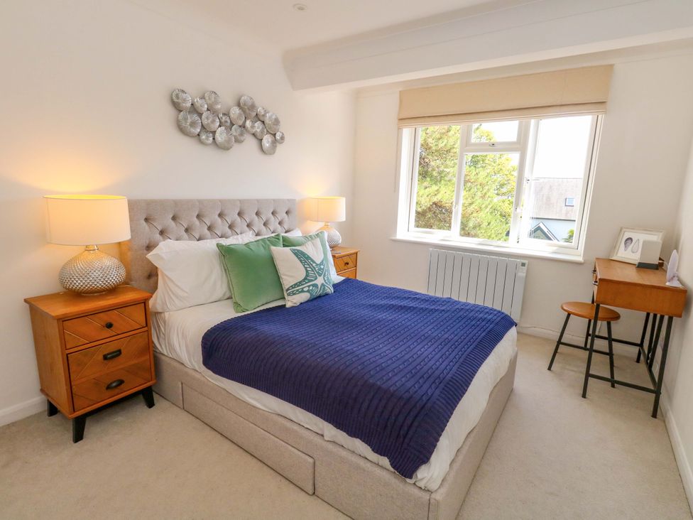 A bedroom with a bed and a desk at Apartment 11 in Poole