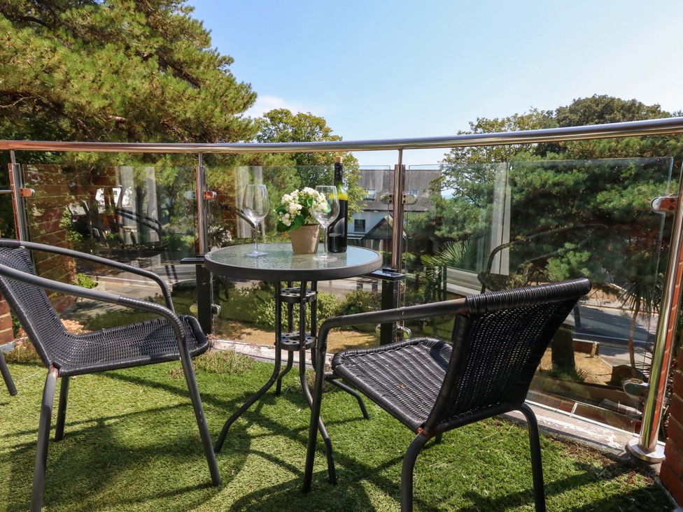 A balcony with a table and chairs at Apartment 11 in Poole