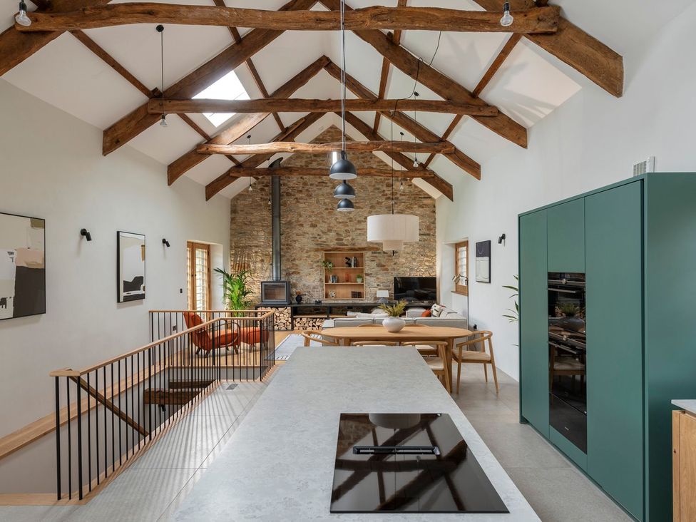 A kitchen with a table and chairs at Lower Walreddon Farm Tavistock