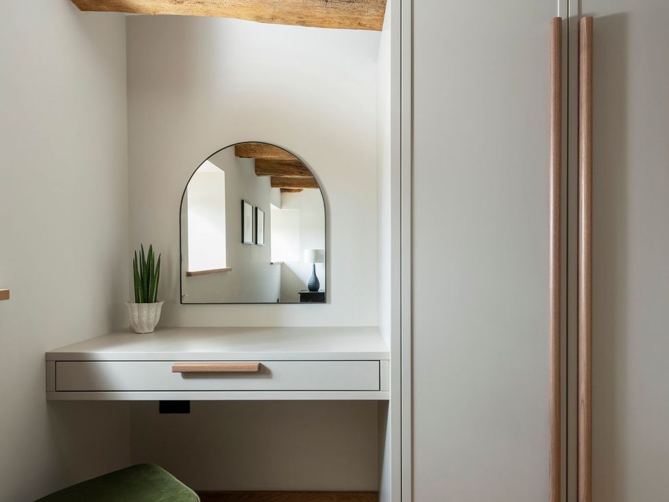 A bathroom with a mirror and a plant at Lower Walreddon Farm Tavistock