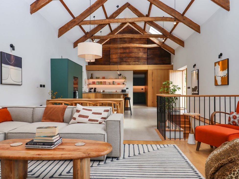 A living room with a sofa and coffee table at Lower Walreddon Barn in Tavistock