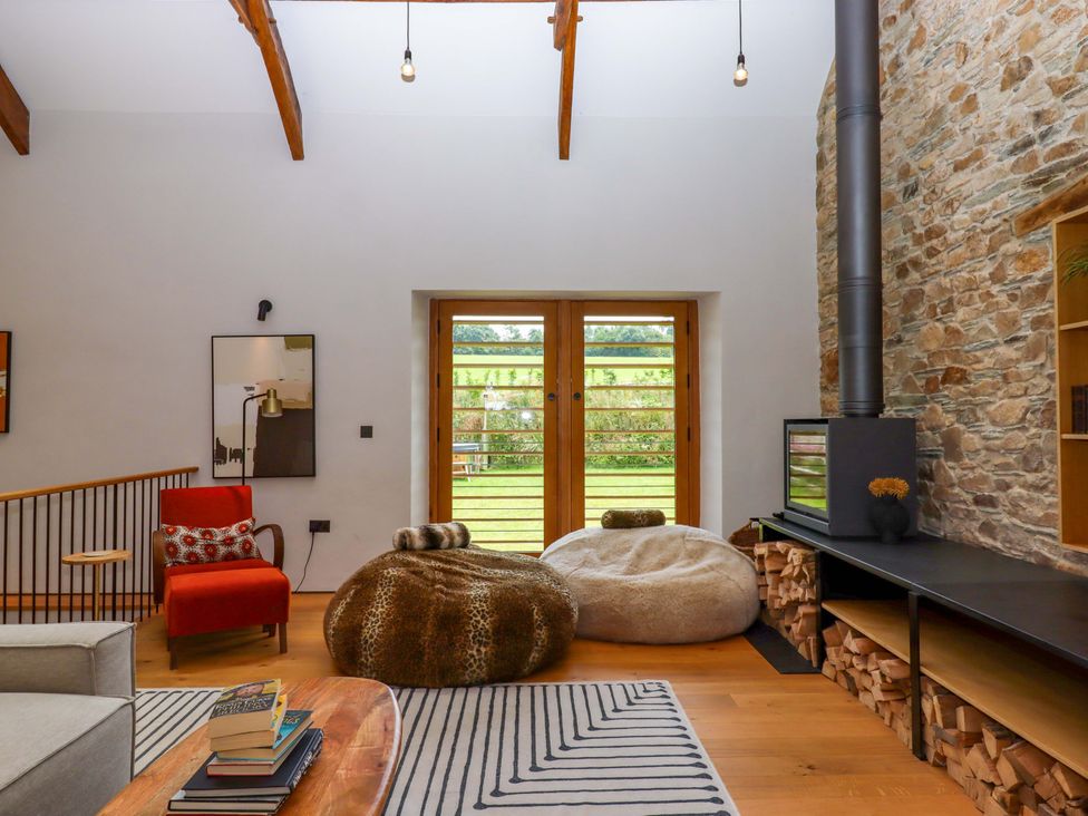 A living room with a sofa and bean bags at Lower Walreddon Barn in Tavistock