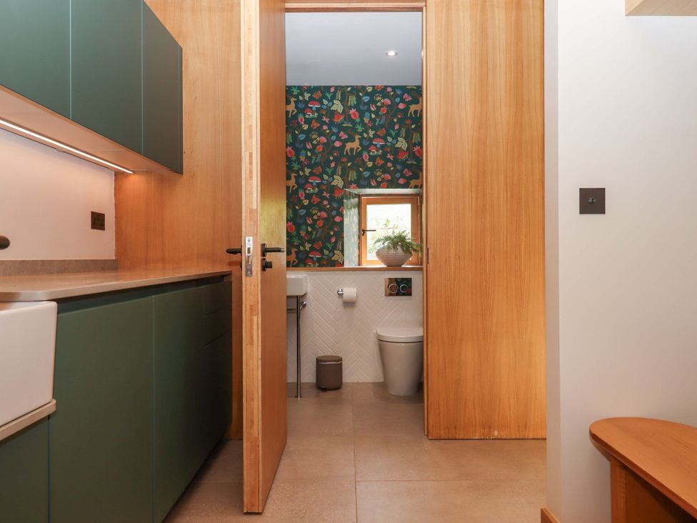 A bathroom with a sink and toilet at Lower Walreddon Barn in Tavistock