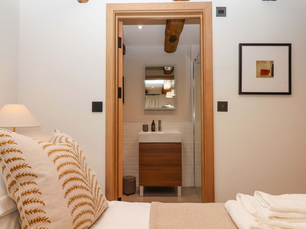 A bedroom with a view of the bathroom at Lower Walreddon Barn Tavistock
