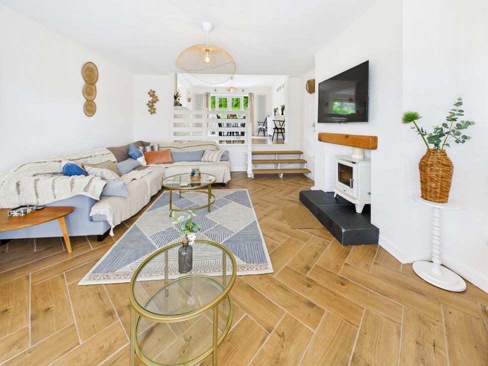 A living room with a sofa and coffee table at 59a Gwscwm Road