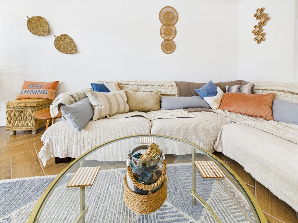 A living room with a sofa and coffee table at 59a Gwscwm Road