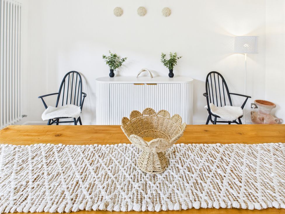 A dining room with a table and chairs at 59a Gwscwm Road