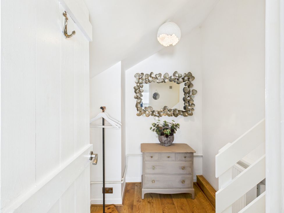 A hallway with a dresser and mirror at 59a Gwscwm Road