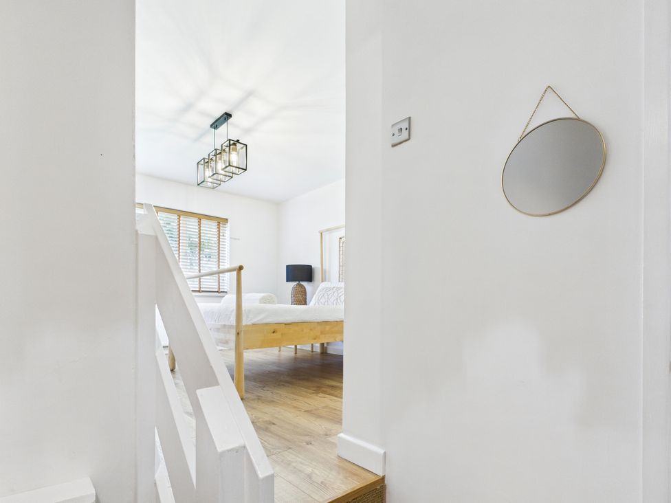 A bedroom with a bed and lamp at 59a Gwscwm Road