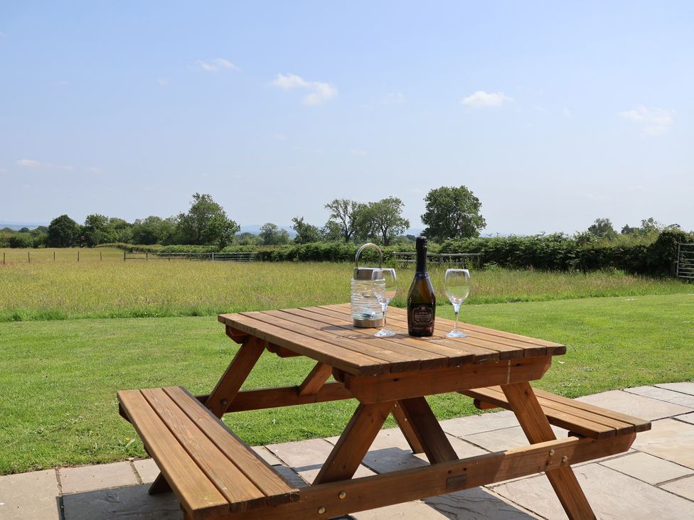 A picnic table with drinks in a field at Honeypot Hideaways - Manuka