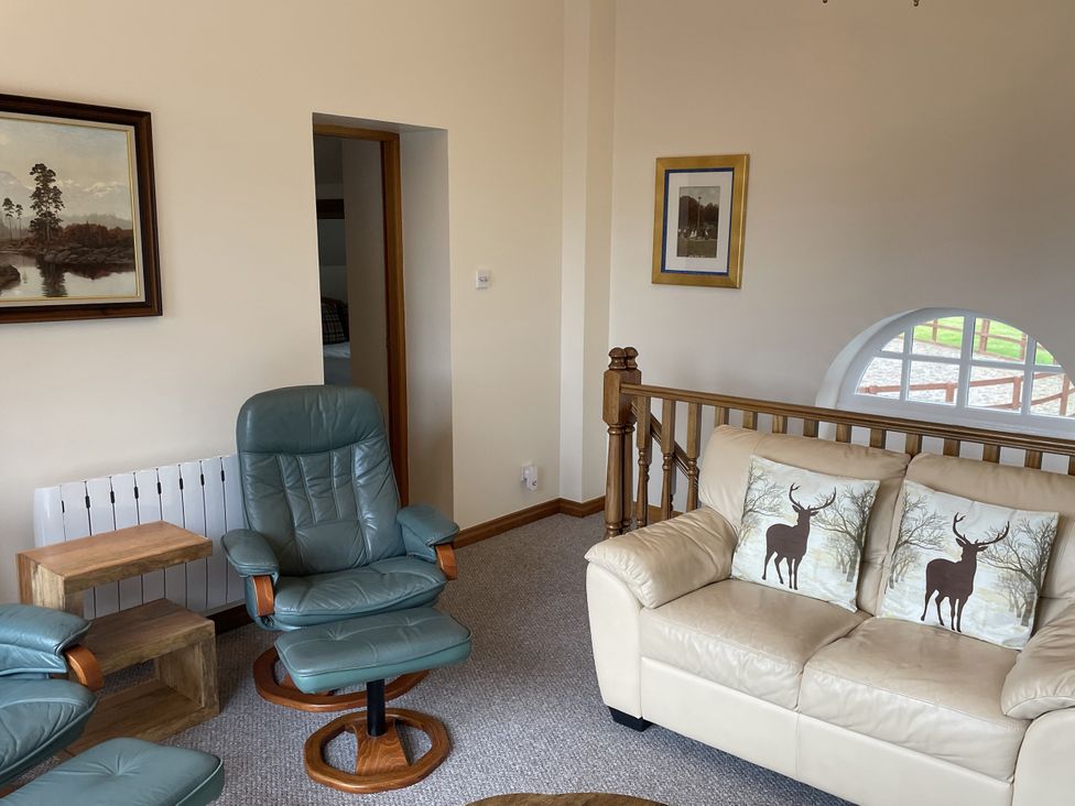 A living room with a recliner chair and a sofa at The ClockTower in Perth