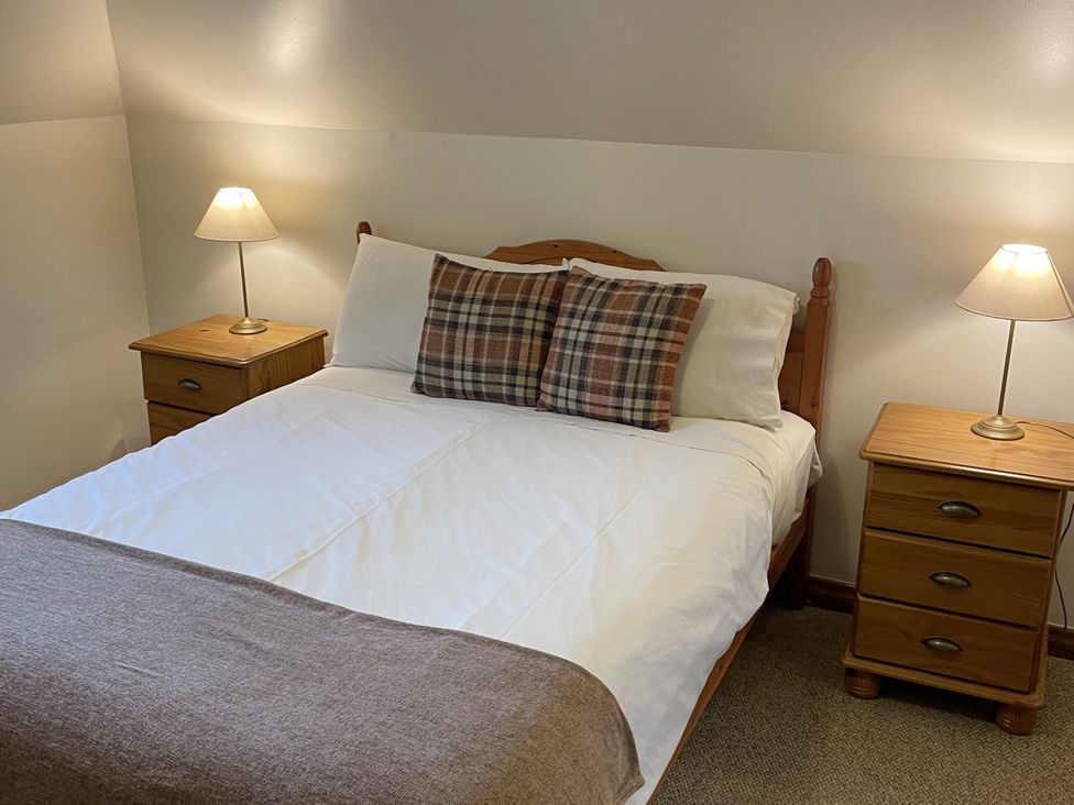 A bedroom with a bed and nightstands at The ClockTower in Perth