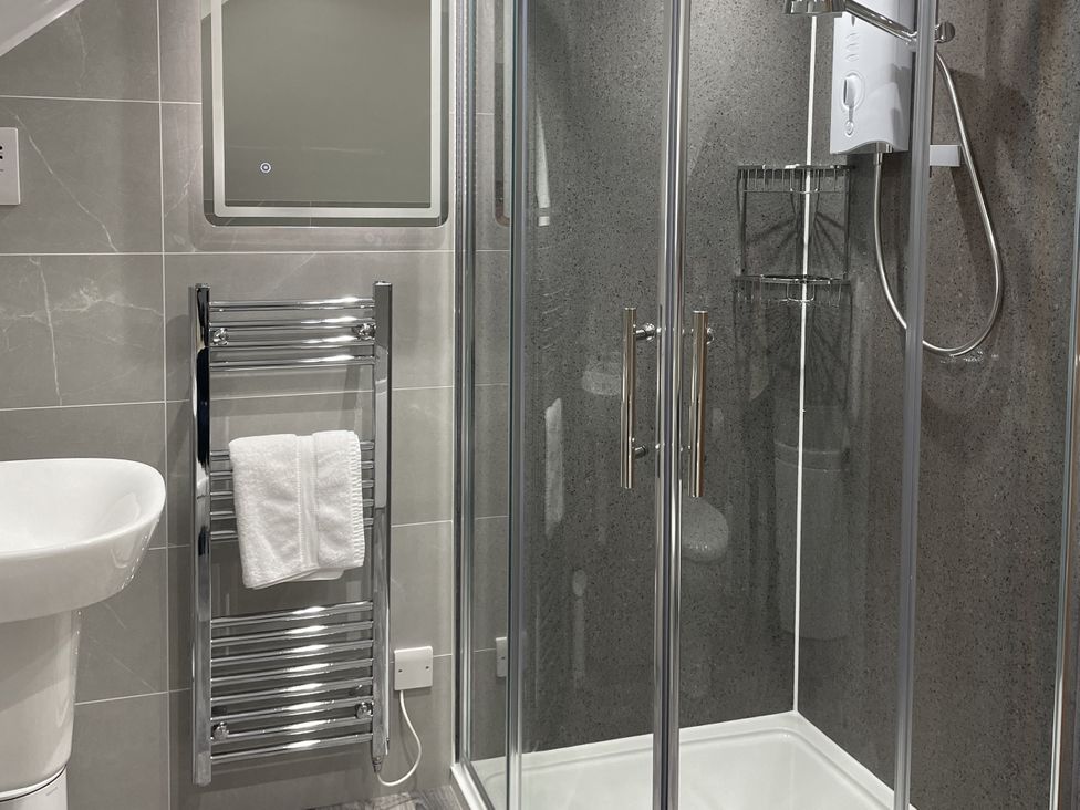 A bathroom with a shower and towel rail at The ClockTower in Perth