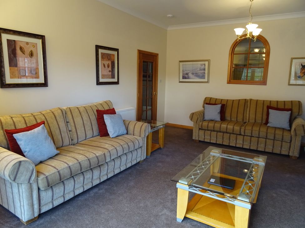 A living room with sofas and a coffee table at Coach House 4 in Perth