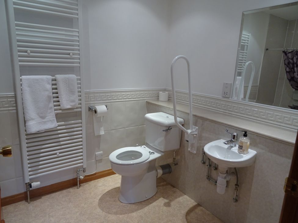 A bathroom with a toilet and sink at Coach House 4 Perth