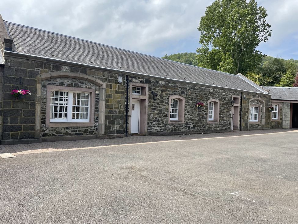 A stone building with windows and door at Coach House 5 in Perth