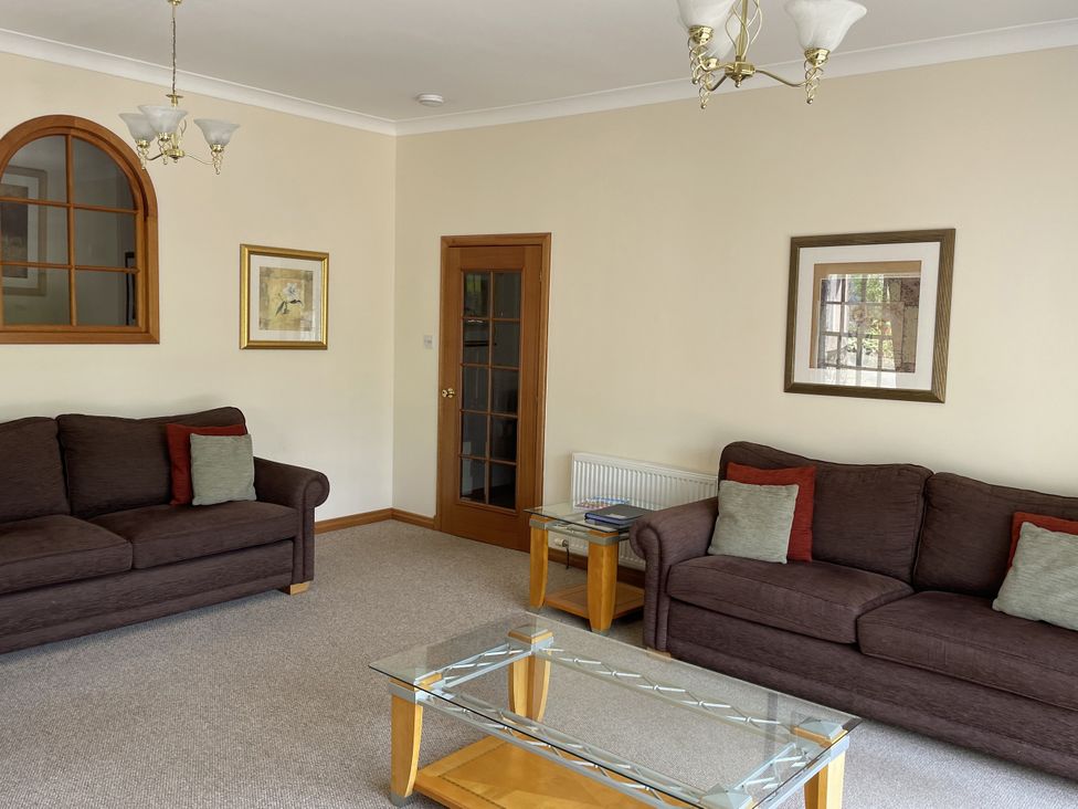 A living room with sofas and a coffee table at Coach House 5 in Perth