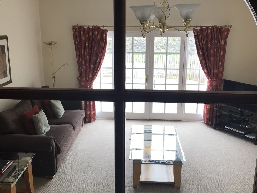 A living room with a sofa and coffee table at Coach House 5 Perth